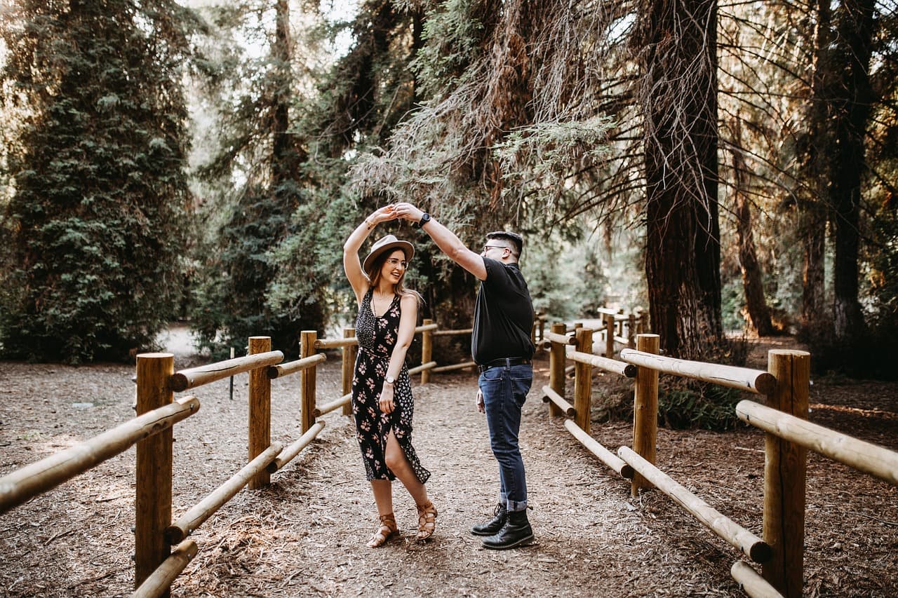 a couple dances on a path in the park