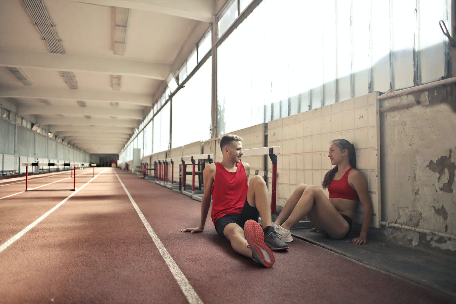 Two friends resting on floor after training