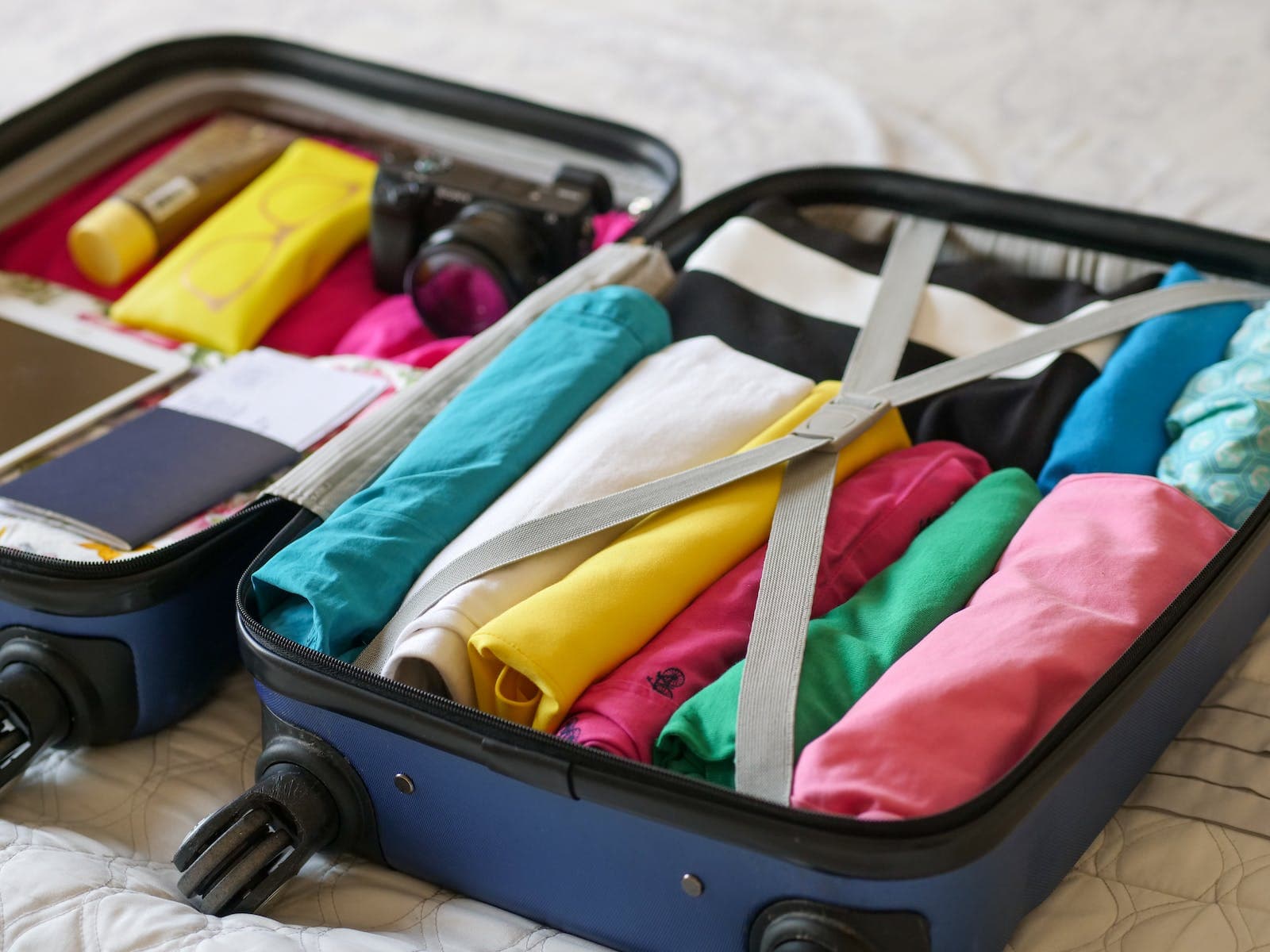 Blue Hard-Shell Luggage with Folded Clothes