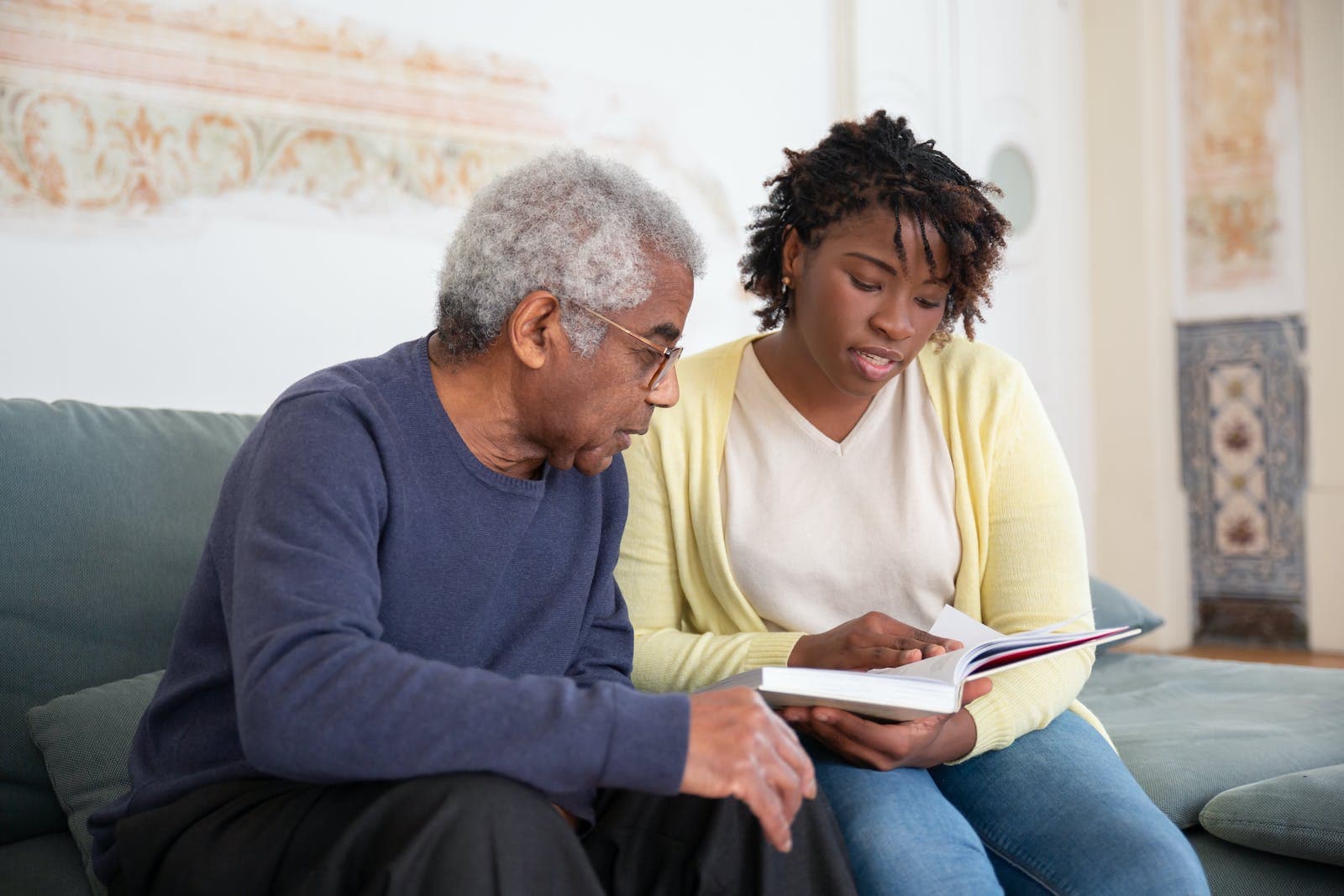 a woman sits beside an elder