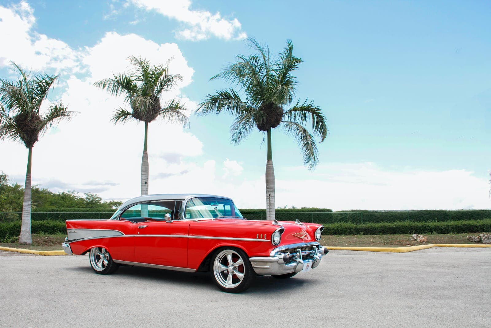 Red Coupe Chevy Near Trees Under White Clouds