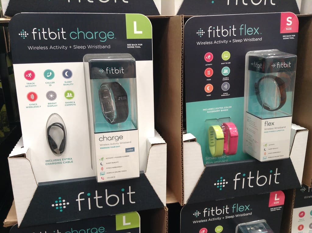 two fitbits displayed on a shelf in the store