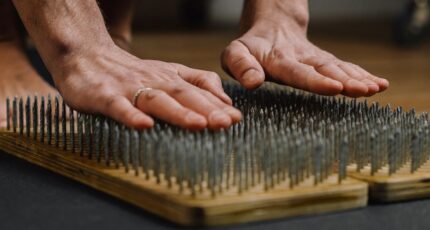 A Person Leaning on Bed of Nails