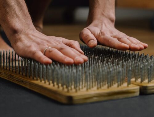 A Person Leaning on Bed of Nails
