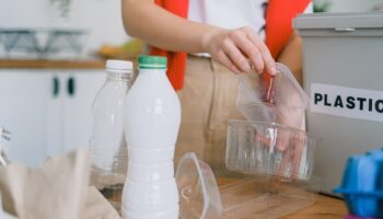 Woman sorting out plastic wastes at home