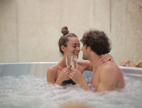 Happy couple having fun in jacuzzi during romantic date