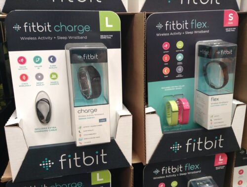 two fitbits displayed on a shelf in the store