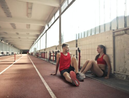 Two friends resting on floor after training