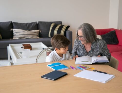 Grandmother helping her Grandchild with his Studies