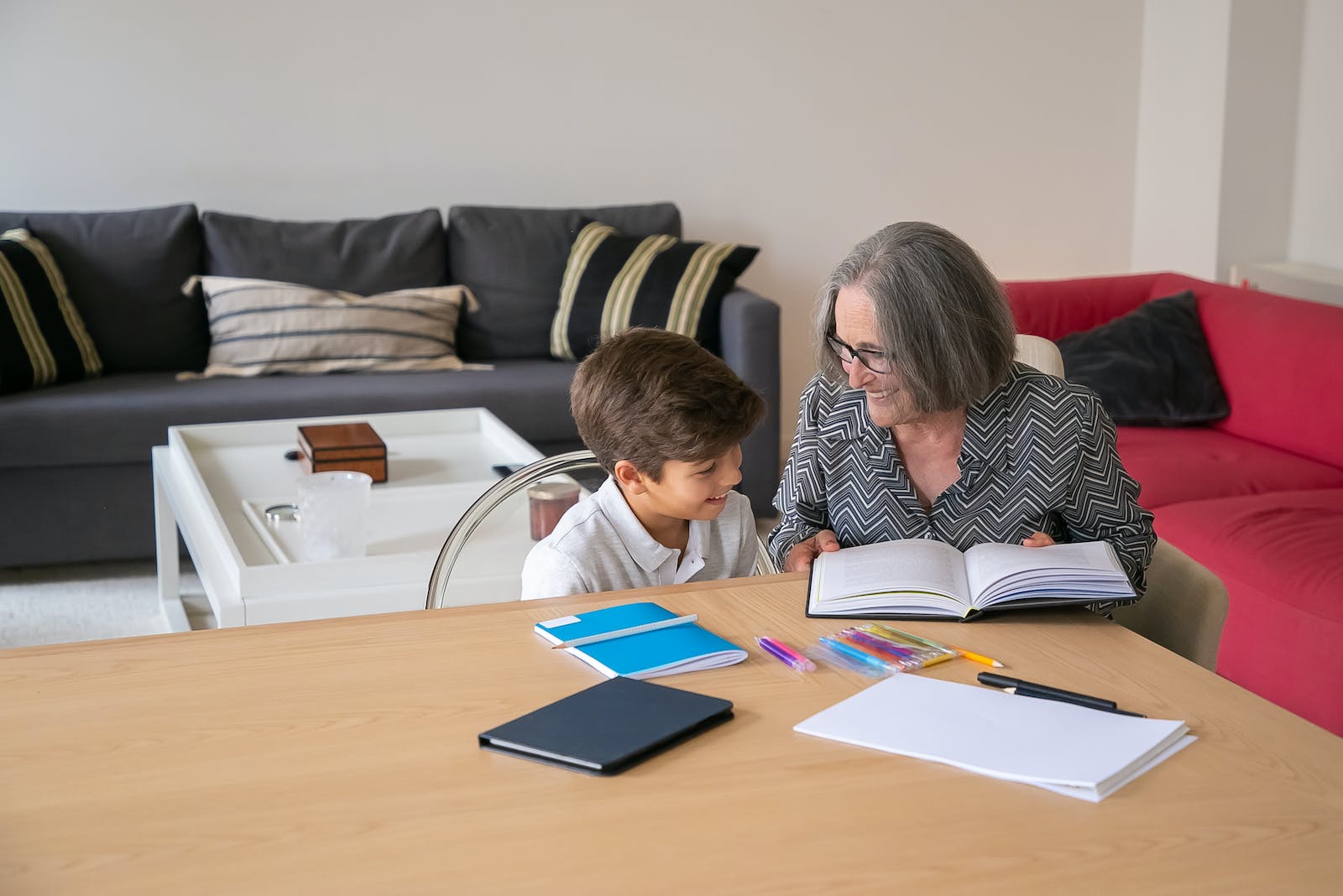 Grandmother helping her Grandchild with his Studies