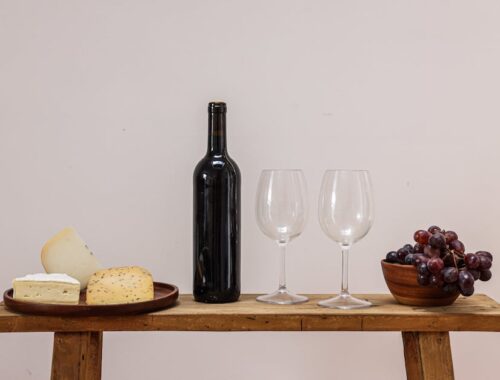 Wine Bottle and Wine Glasses on a Brown Wooden Table