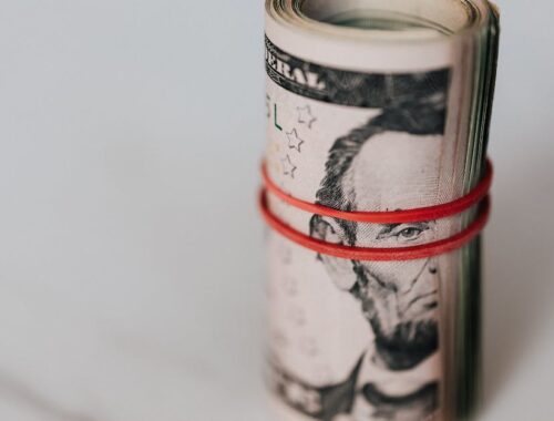Roll of american dollars tightened with red band