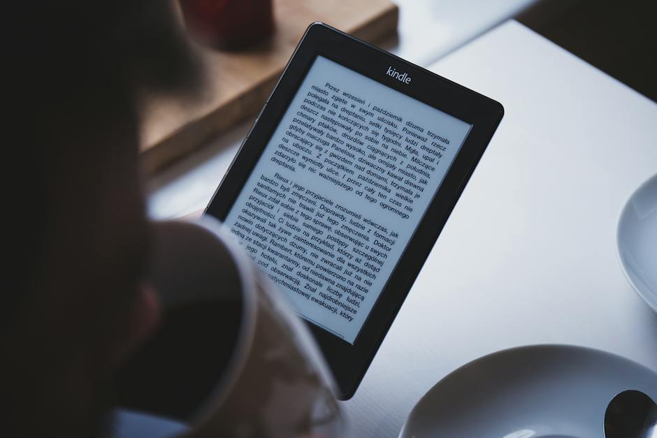 Person Using E-book Reader While Drinking Coffee