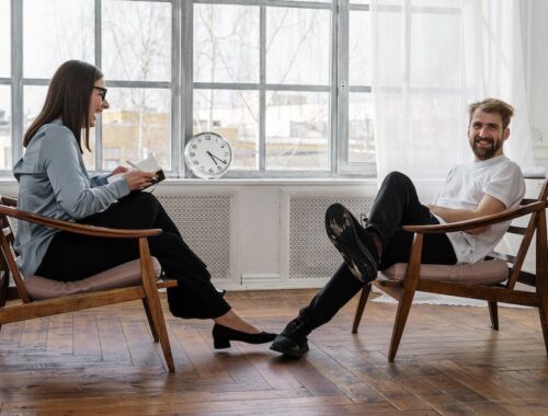 2 People Sitting on Brown Wooden Chair