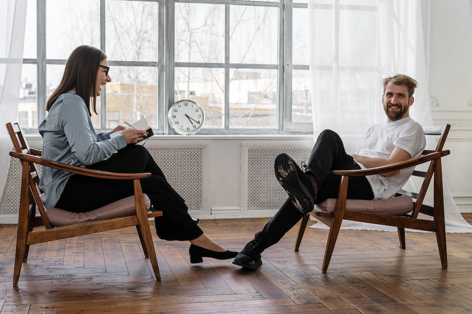 2 People Sitting on Brown Wooden Chair