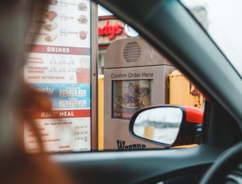 Person ordering fast food in drive thru