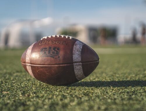 Selective Focus Close-up Photo of Brown Wilson Pigskin Football on Green Grass