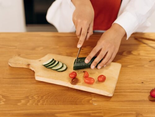 Woman Slicing A Cucumber