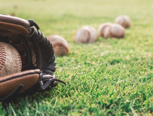 White Baseball Ball On Brown Leather Baseball Mitt