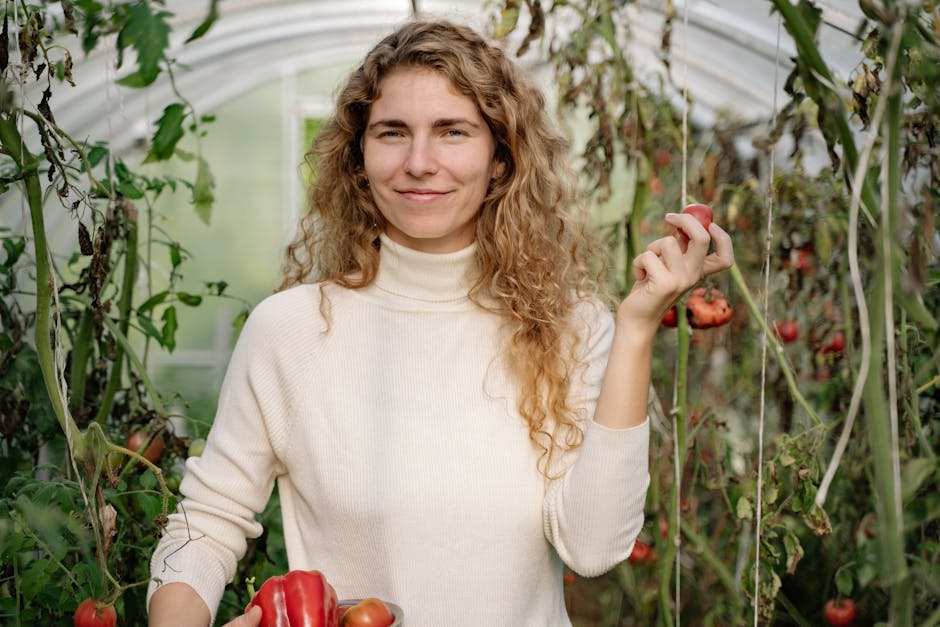 Close-Up Shot of a Woman in White Long Sleeves Holding a Bowl of Fruits