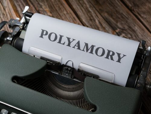 A typewriter with the word polyamory written on it