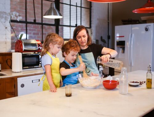 A Mom Cooking with her Kids in a Kitchen