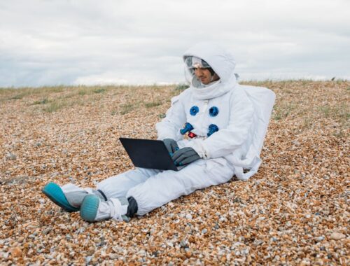 Man In A Space Suit Using Laptop